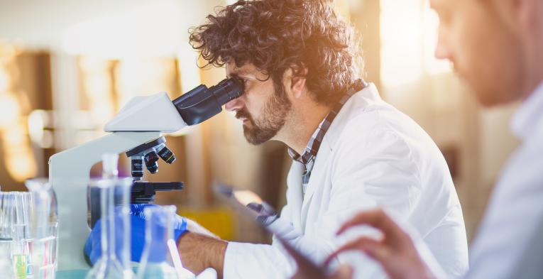 Doctor using microscope