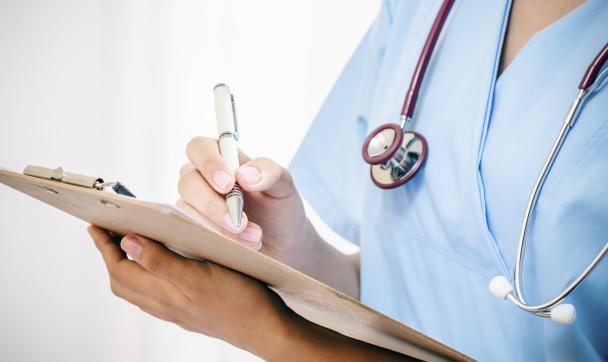 nurse taking notes at ward round