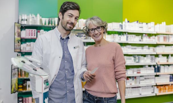 pharmacist and his customer smiling