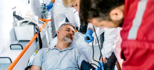 Doctor and paramedics help man